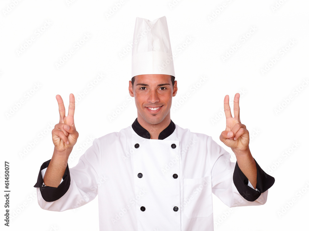 Professional male chef with victory fingers Professional male chef with victory fingers