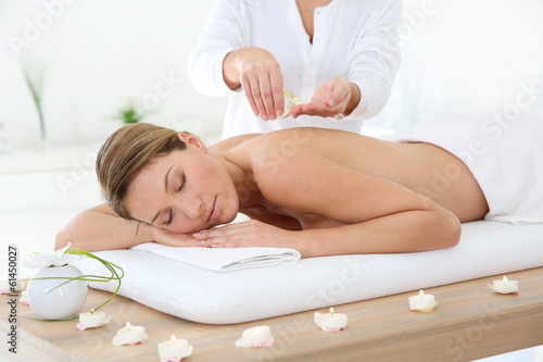 Woman in spa institute receiving oil massage