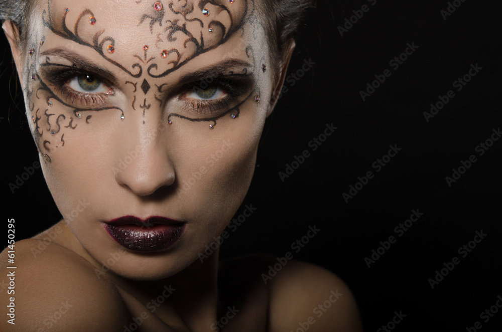 Woman with dark lace pattern on the face