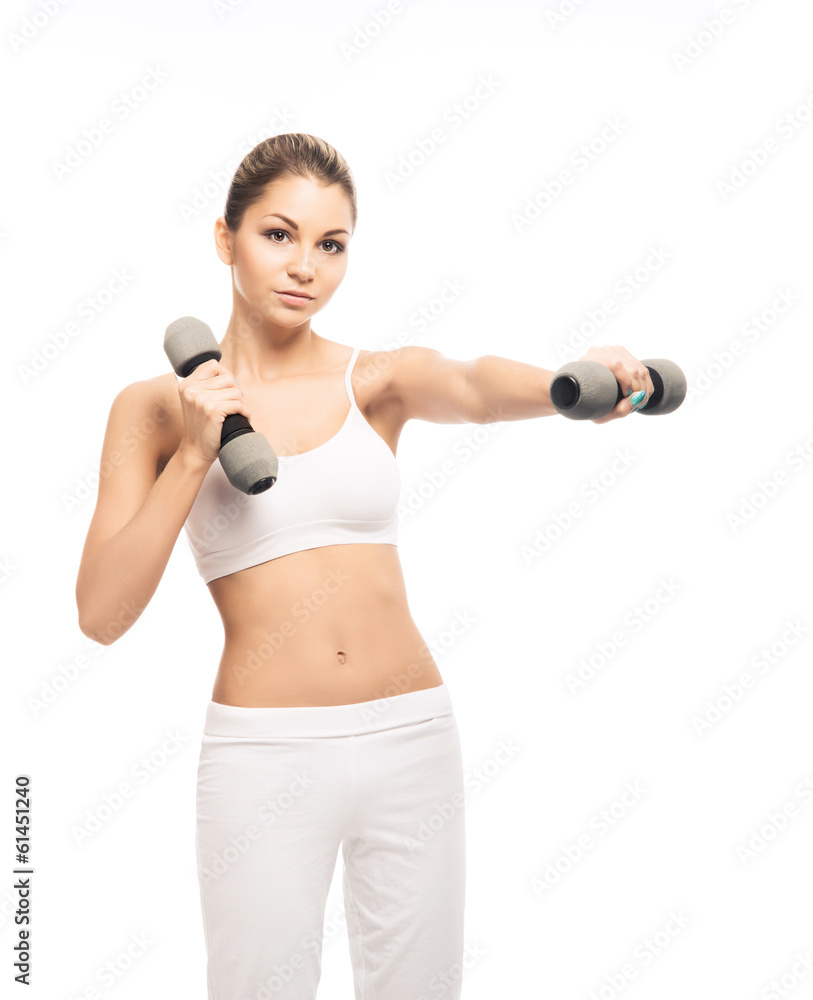 A fit and beautiful woman training with dumbbells on white A fit and beautiful woman training with dumbbells on white