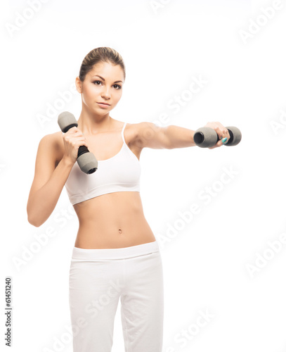 A fit and beautiful woman training with dumbbells on white