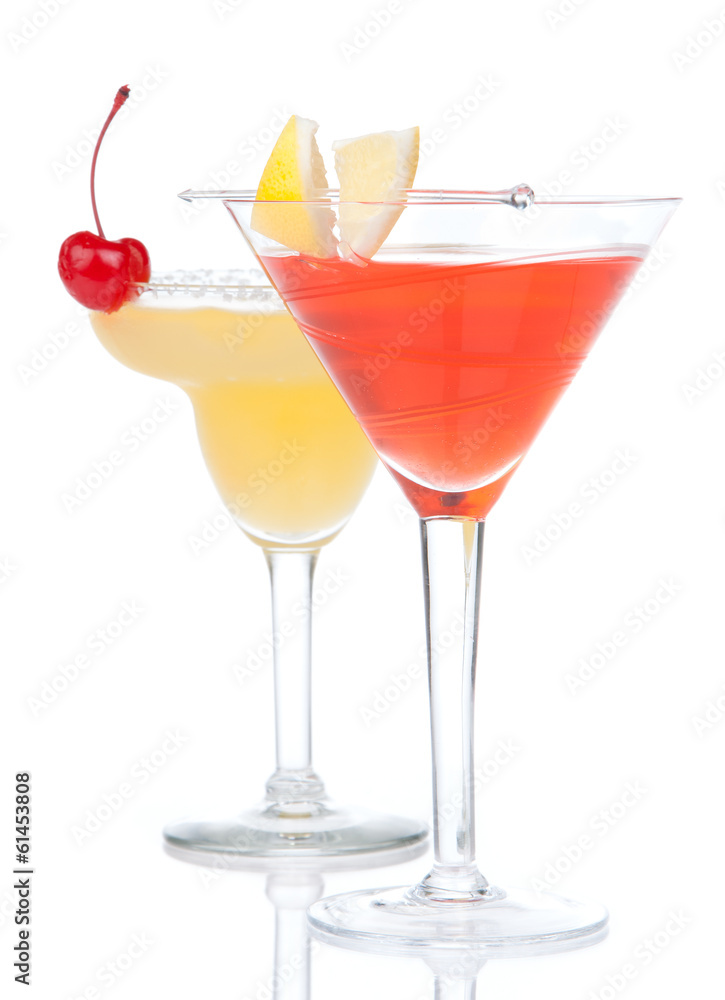 Two cocktail drinks yellow margarita cherry and tropical Martini