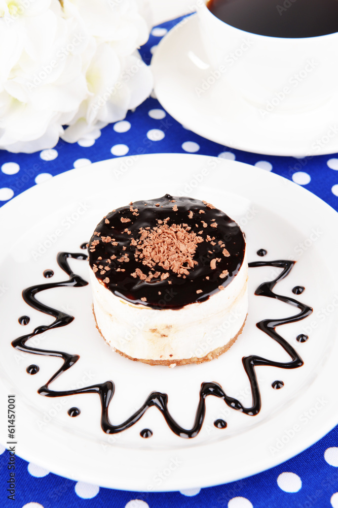 Sweet cake with chocolate on plate on table close-up Sweet cake with chocolate on plate on table close-up
