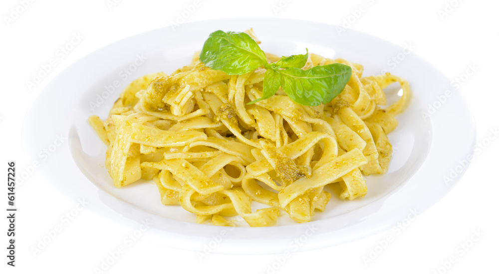 Delicious pasta with pesto on plate isolated on white Delicious pasta with pesto on plate isolated on white