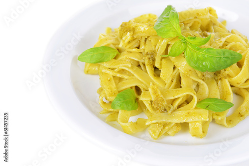Delicious pasta with pesto on plate close-up