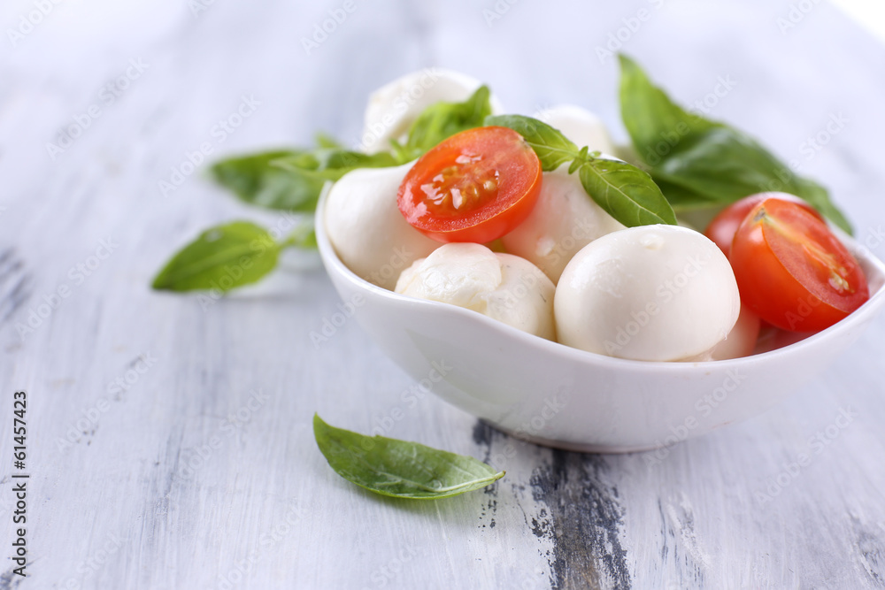 Tasty mozzarella cheese with basil and tomatoes in bowl, Tasty mozzarella cheese with basil and tomatoes in bowl,