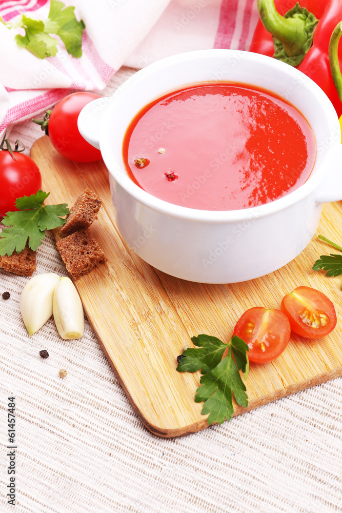 Tasty tomato soup and vegetables, close up Tasty tomato soup and vegetables, close up
