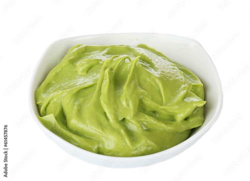 Fresh guacamole in bowl isolated on white Fresh guacamole in bowl isolated on white