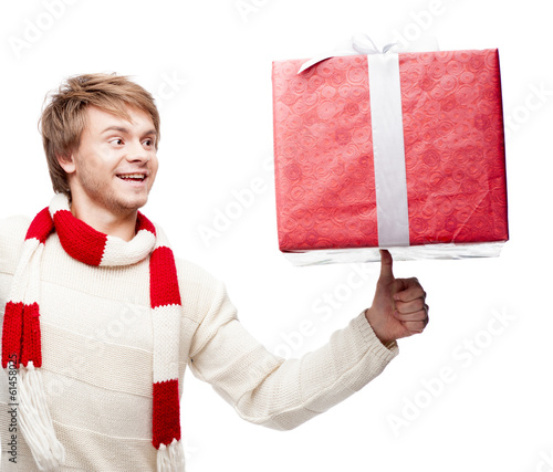 young smiling man holding christmas gift