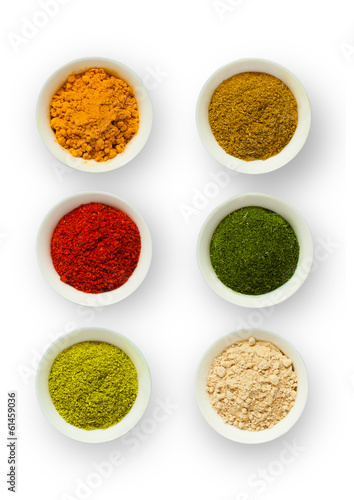 Various spices in a cup on a white background