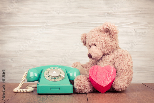 Teddy Bear with heart box near retro telephone