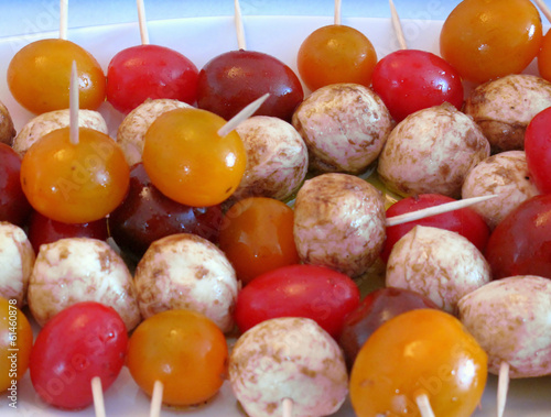 Marinated bocconcini and cherry tomatoes on skewers photo