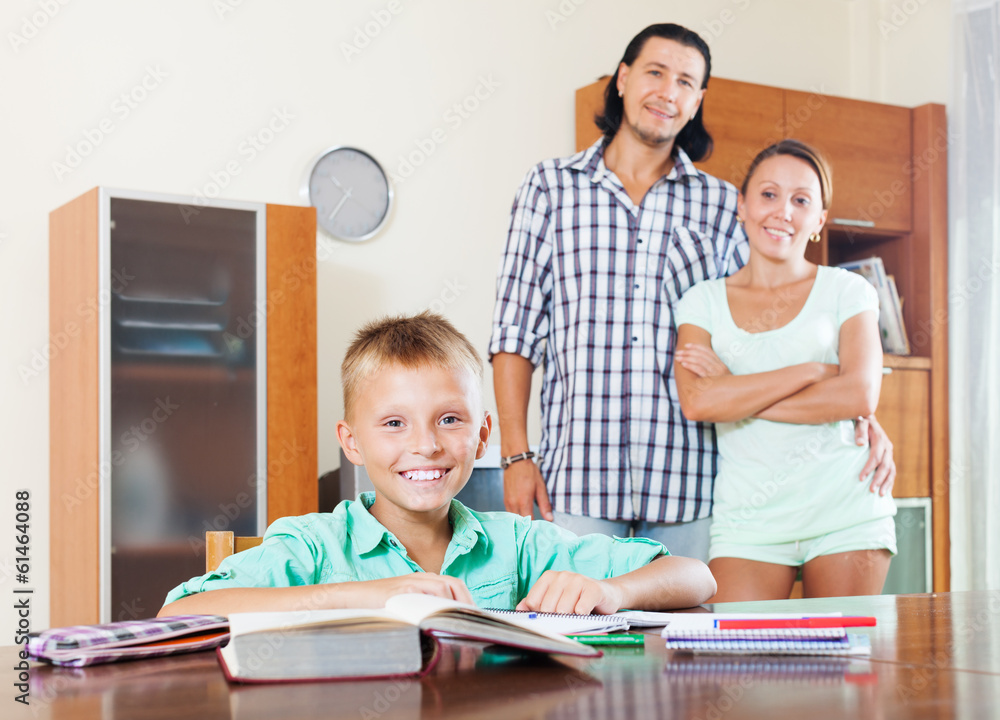 Fototapeta premium Happy schoolboy doing homework