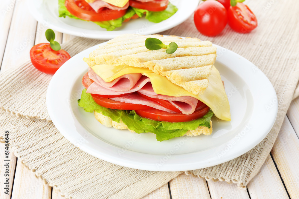 Tasty sandwich with ham on wooden table Tasty sandwich with ham on wooden table