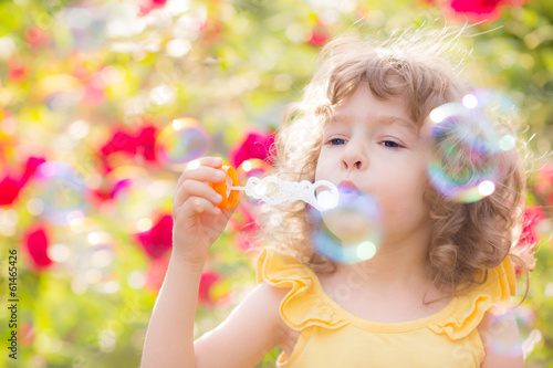 Kid blowing soap bubbles
