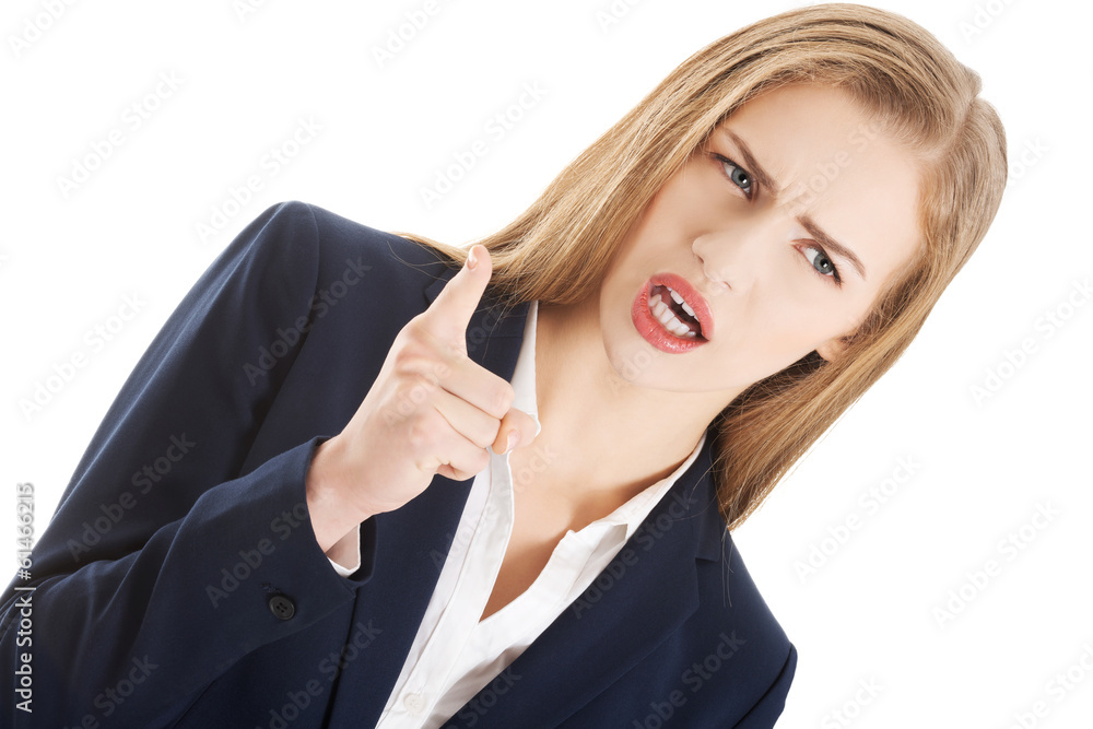 Beautiful business woman is showing warning sign. Beautiful business woman is showing warning sign.
