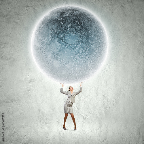 Billede på lærred Businesswoman lifting moon