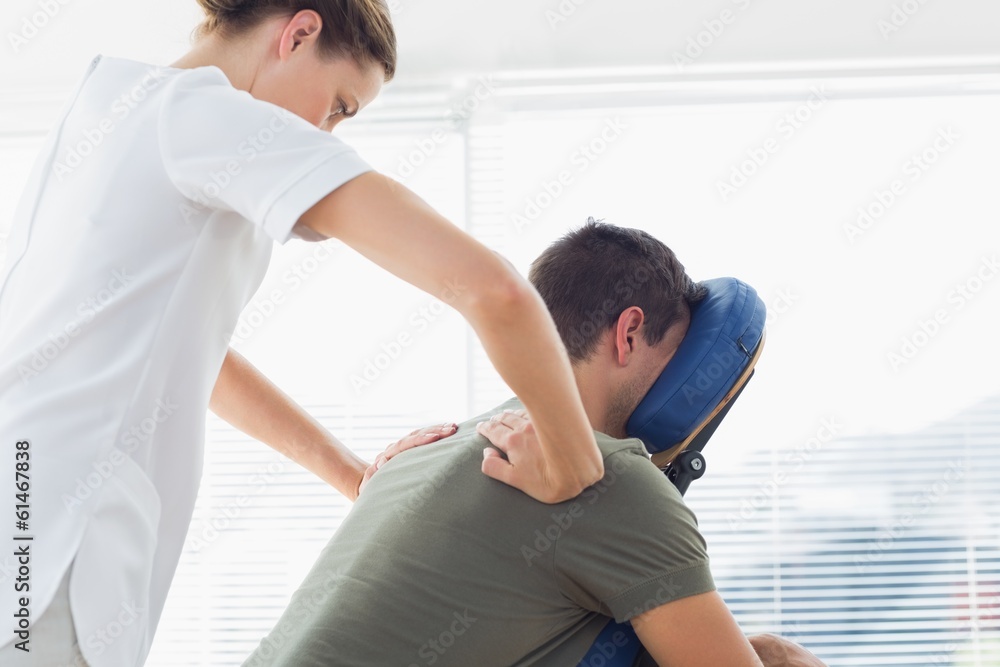 Fototapeta premium Physiotherapist giving back massage to man