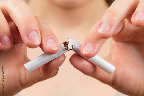 woman breaking a cigarette, quit smoking concept,