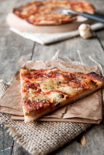 close up of homemade pizza on old wooden table,natural light
