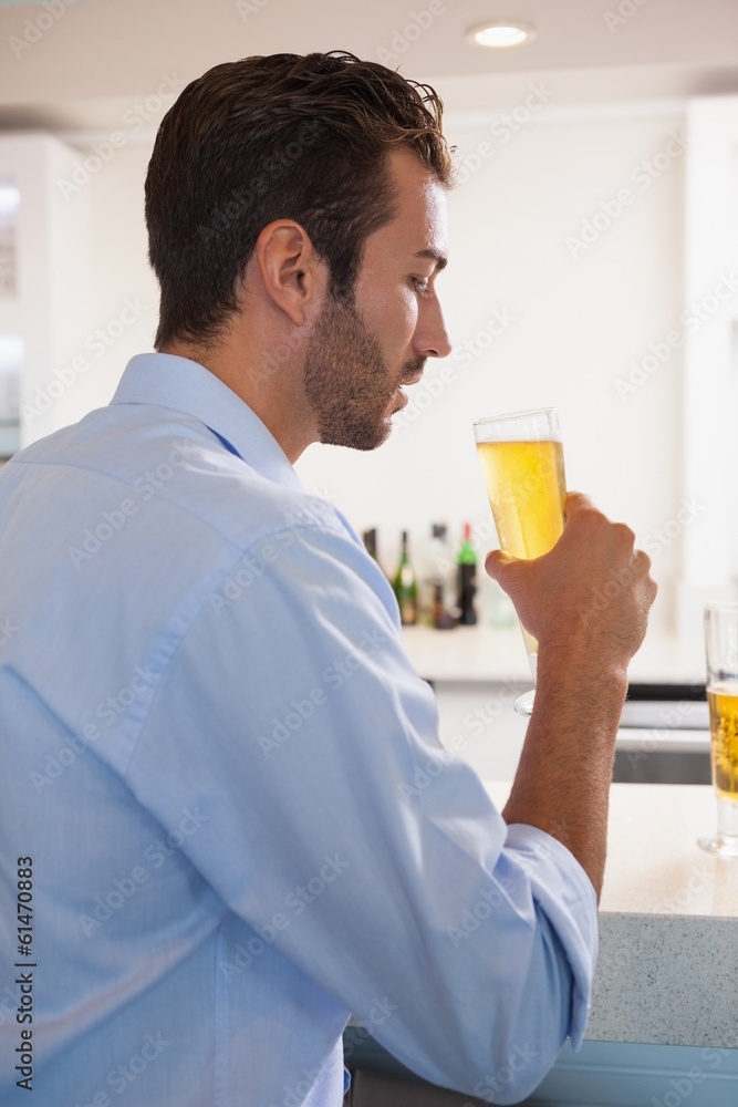Handsome businessman drinking glass of beer after work Handsome businessman drinking glass of beer after work