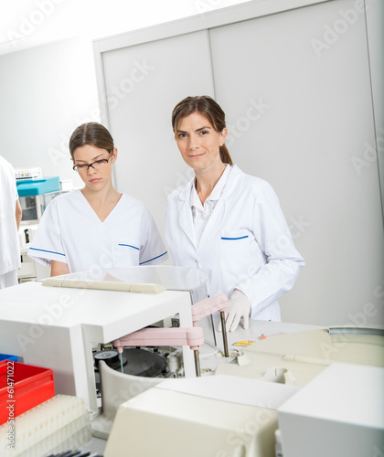 Researcher With Colleague In Laboratory