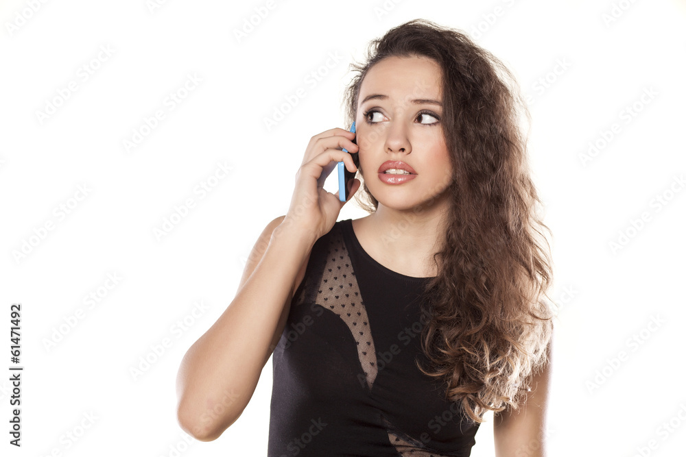 worried young teenager girl talking on the phone worried young teenager girl talking on the phone