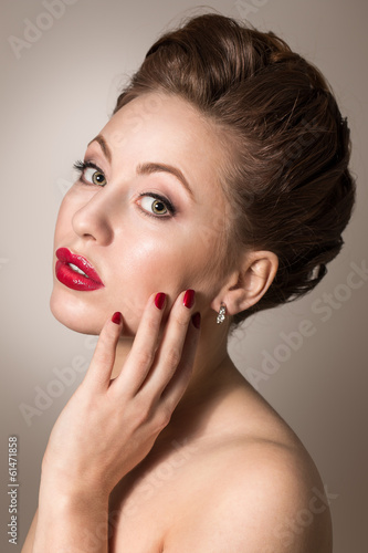 Young woman with red lips and polished nails.Professional makeup