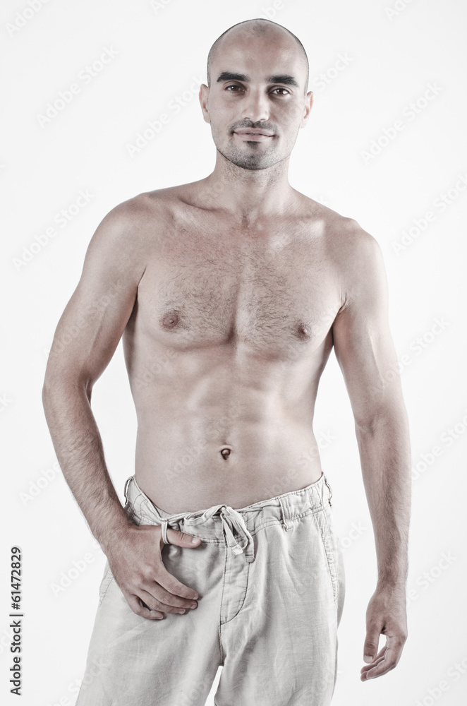 Fototapeta premium Topless bodybuilder showing his fit body with six pack abs. 