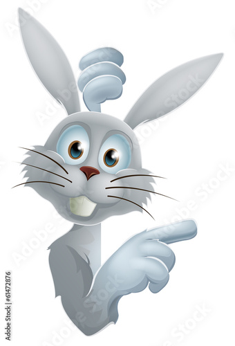 Easter bunny pointing at sign