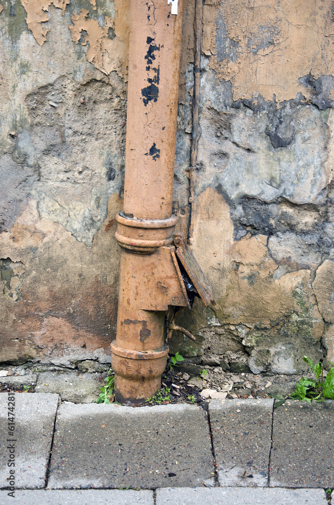 rain water draining gutter downpipe on old house wall rain water draining gutter downpipe on old house wall