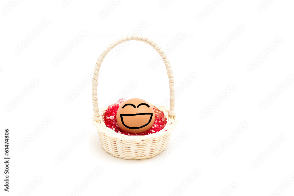 egg with happy face on white background in wicker basket