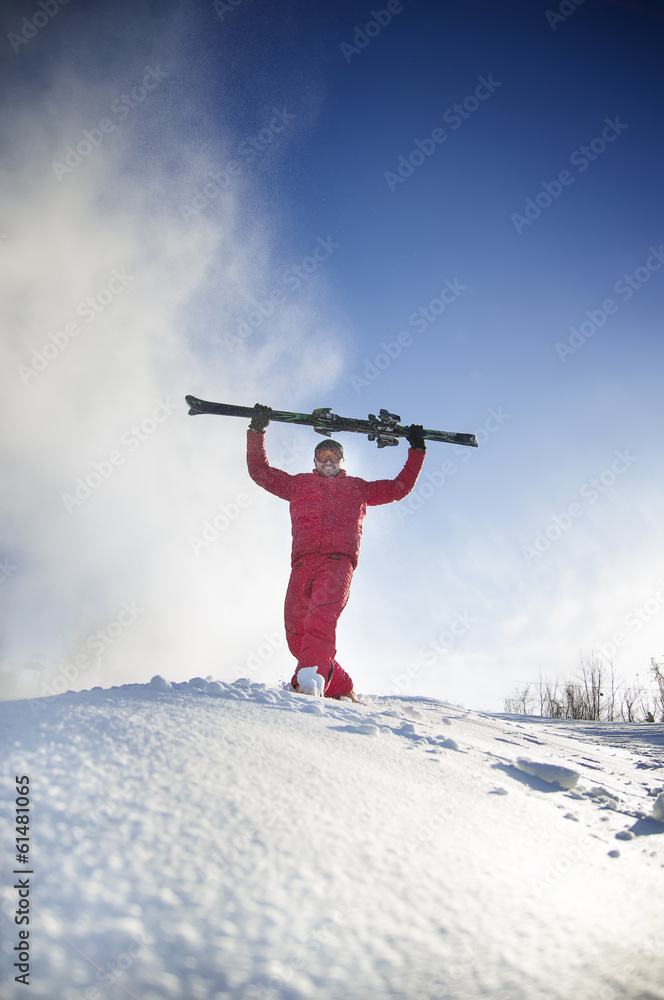 Skier man is posing at camera.