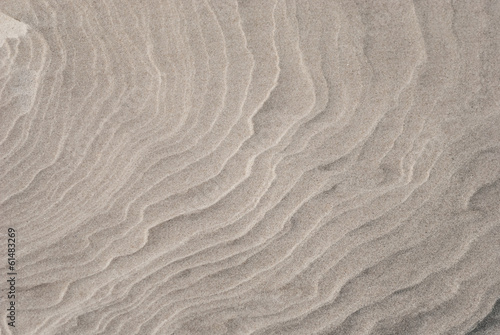 Closeup of sand pattern of a beach in the summer
