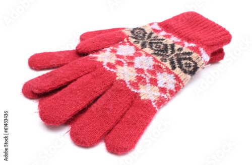 Pair of red woolen gloves on white background