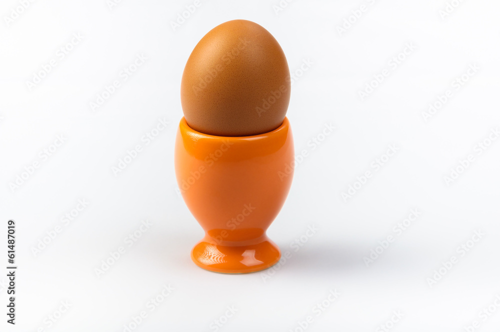 Orange egg cup  on white background