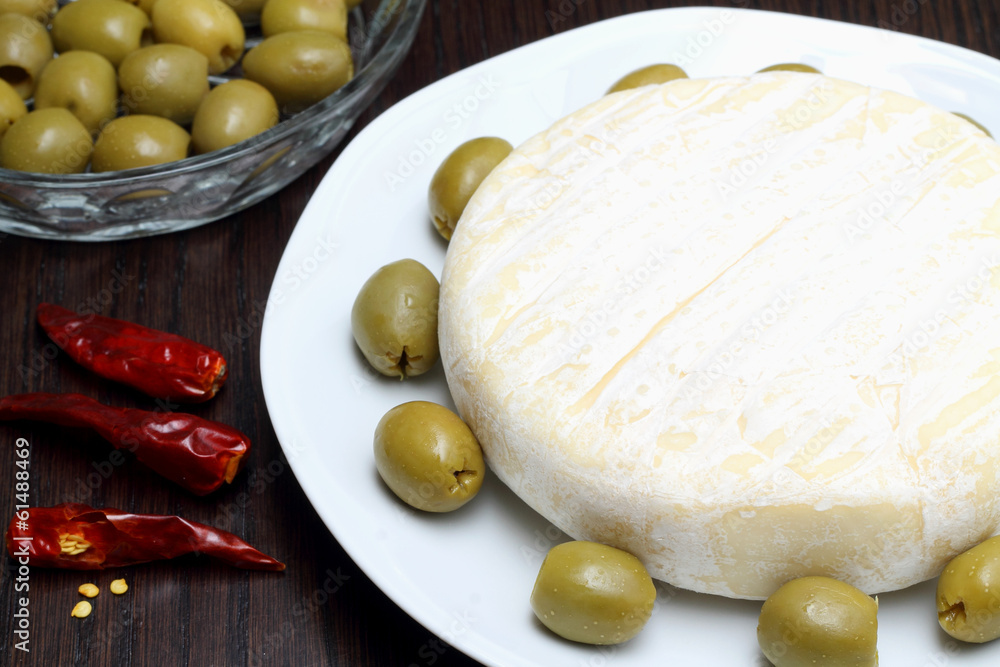 Cheese with green olives and red chili peppers