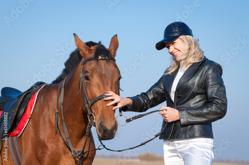 Laughing woman and horse on the sky background