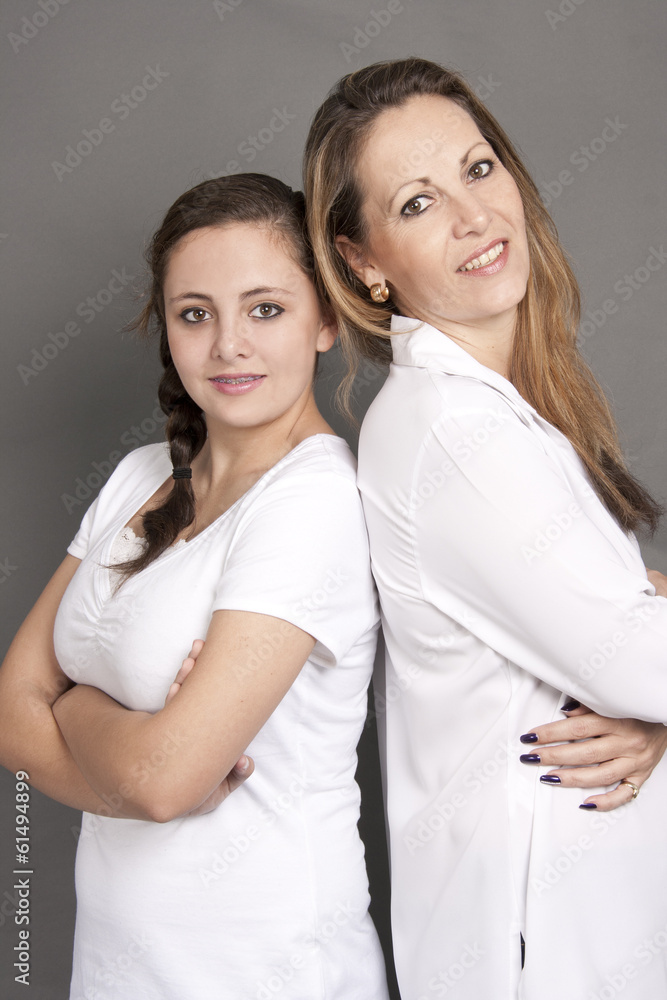 Mother with daughter standing back to back Mother with daughter standing back to back