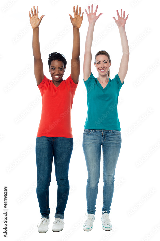 Women raising their arms up in excitement Women raising their arms up in excitement