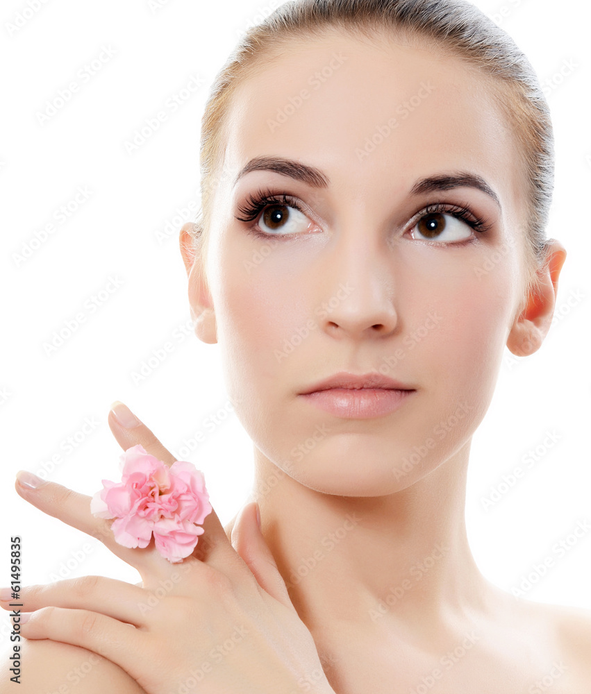 The beautiful woman holds a flower of a carnation at the face The beautiful woman holds a flower of a carnation at the face