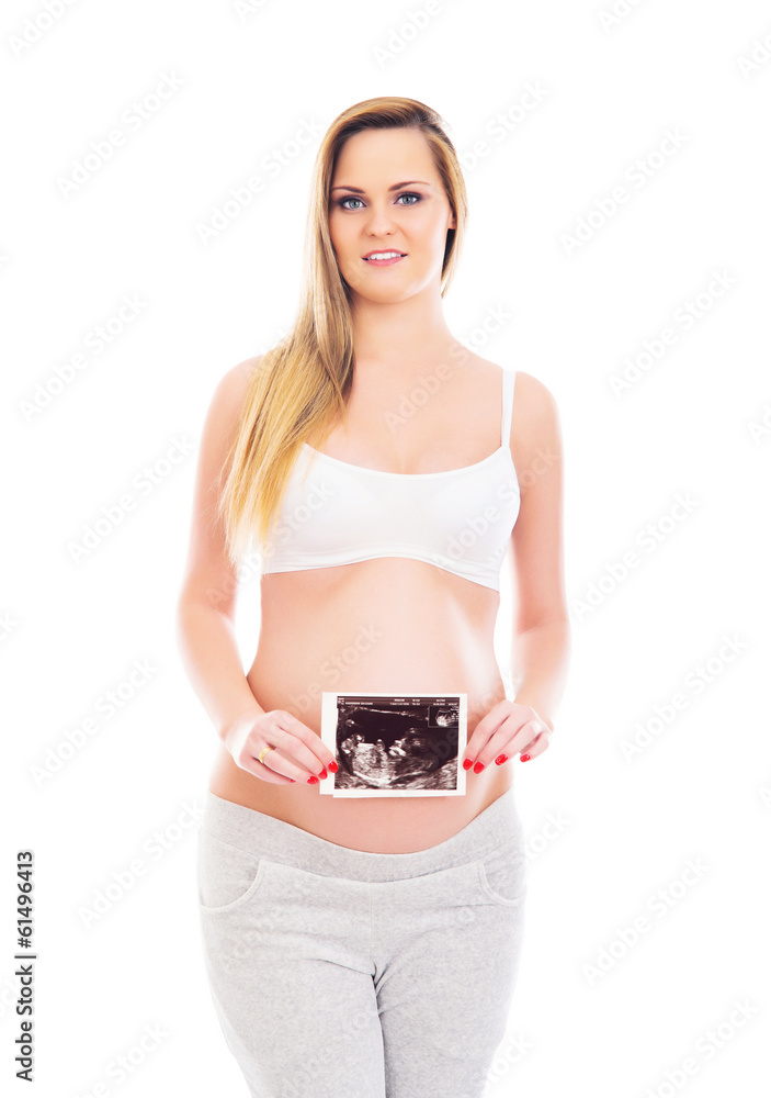A pregnant blond woman holding an ultrasound A pregnant blond woman holding an ultrasound