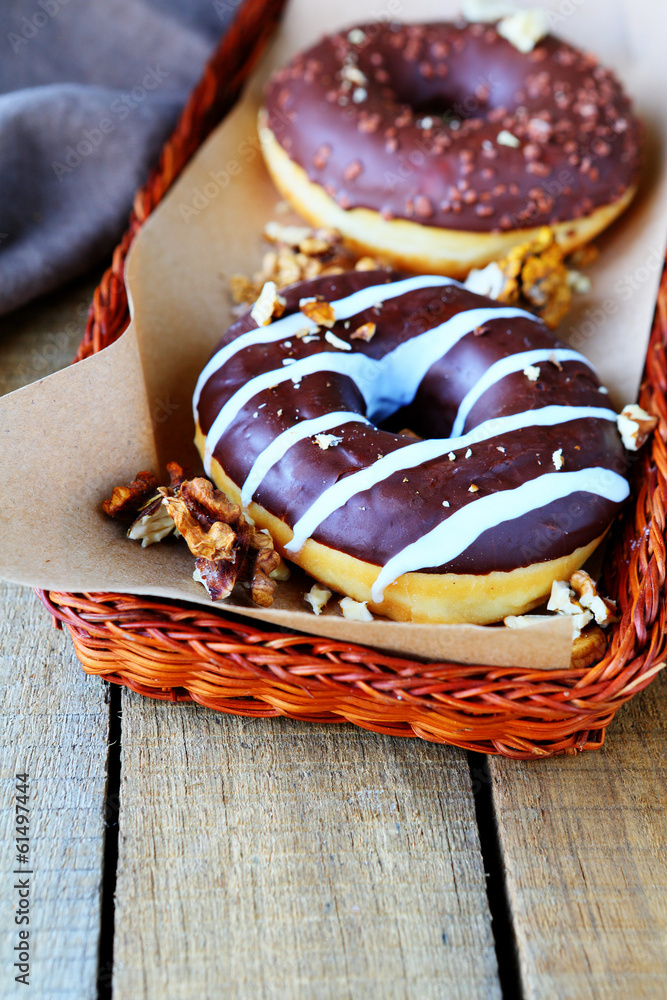two chocolate donuts with nuts two chocolate donuts with nuts
