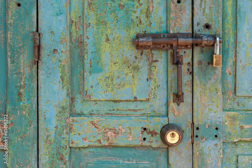 Old Brass Padlock on Wooden Green Door