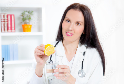 doctor holding a glass of water and lemon