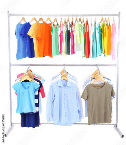 Different clothes on hangers  on gray background