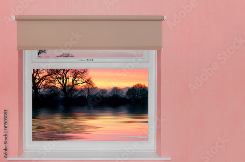 View of sunset over lake a window