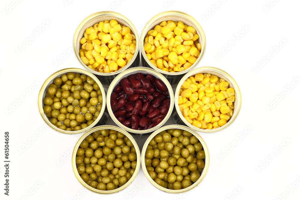 The tins with peas, red bean, corn on the white background The tins with peas, red bean, corn on the white background