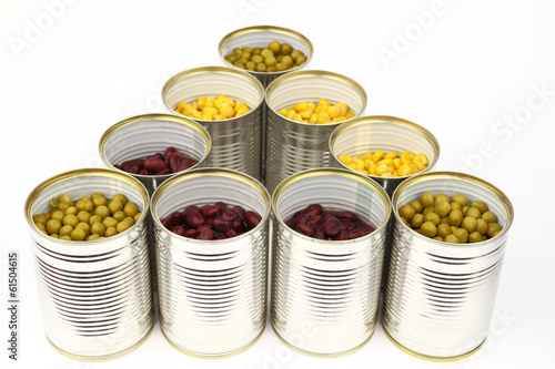 The tins with peas, red bean, corn on the white background
