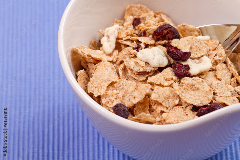 granola and fresh blueberries, in glass bowl over wood backgroun granola and fresh blueberries, in glass bowl over wood backgroun